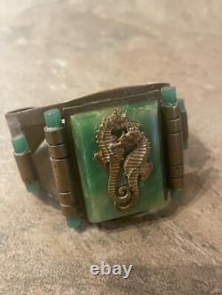 Art Nouveau cuff bracelet with seahorses on green bakelite. Good condition wide
