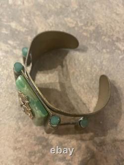 Art Nouveau cuff bracelet with seahorses on green bakelite. Good condition wide