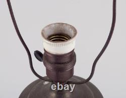 German ceramicist. Art Nouveau table lamp in in light and brown-green tones